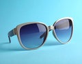 Stylish sunglasses on blue background. Fashionable accessory Royalty Free Stock Photo
