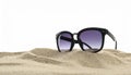 Stylish sunglasses on sand against white background. Space for text Royalty Free Stock Photo