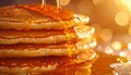 Extreme close up of stacked pancakes with golden maple syrup dripping down sides under warm bright lighting and bokeh background Royalty Free Stock Photo