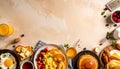 Overhead flat lay of american breakfast with pancakes fried eggs toast fruit and orange juice arranged on beige background Royalty Free Stock Photo