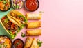 Flat lay of assorted international fried appetizers with spring rolls samosas and tacos served with dipping sauces Royalty Free Stock Photo