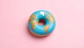 Top down view of glazed doughnut with blue icing and edible world map design symbolizing global food culture Royalty Free Stock Photo