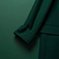 Folded Wool Coat on Matte Dark Green Surface, Sleeve Visible Royalty Free Stock Photo