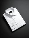 Folded White Dress Shirt on Smooth Matte Black Surface Royalty Free Stock Photo