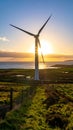 The sun is setting behind the wind turbine, Royalty Free Stock Photo
