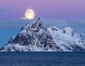 Winter full moon next to the Skolmen mountain peak, Lofoten Islands, Norway Royalty Free Stock Photo
