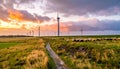 Windmills and Flock of sheep on wind farm against cloudy sky Royalty Free Stock Photo