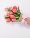 Red tulip bouquet with orange edges wrapped in burlap and pink bow, perfect for birthday gifts and design use Royalty Free Stock Photo