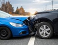 The scene of the car crash where a blue vehicle hit a black car on the road Royalty Free Stock Photo