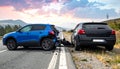 The scene of the car crash where a blue vehicle hit a black car on the road Royalty Free Stock Photo