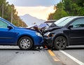 The scene of the car crash where a blue vehicle hit a black car on the road Royalty Free Stock Photo