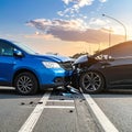 The scene of the car crash where a blue vehicle hit a black car on the road Royalty Free Stock Photo