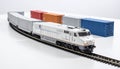 Freight train model with containers on white tabletop, logistics theme Royalty Free Stock Photo