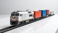Freight train model with containers on white tabletop, logistics theme Royalty Free Stock Photo