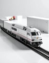 Freight train model with containers on white tabletop, logistics theme Royalty Free Stock Photo