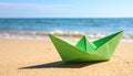 Light green paper boat near sea on sandy beach, space for text Royalty Free Stock Photo