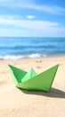 Light green paper boat near sea on sandy beach, space for text Royalty Free Stock Photo