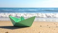 Light green paper boat near sea on sandy beach, space for text Royalty Free Stock Photo