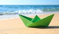 Light green paper boat near sea on sandy beach, space for text Royalty Free Stock Photo