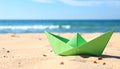 Light green paper boat near sea on sandy beach, space for text Royalty Free Stock Photo
