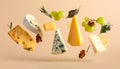 Different types of cheese, crackers, grapes, rosemary and walnuts in air on dark beig Royalty Free Stock Photo
