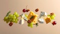 Different types of cheese, crackers, grapes, rosemary and walnuts in air on dark beig Royalty Free Stock Photo