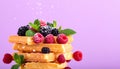 Vibrant Waffle Stack with Fresh Berries and Mint on Purple Background Royalty Free Stock Photo