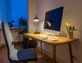 A comfortable workplace with a computer and lamp on the wooden desk in the home Office Royalty Free Stock Photo