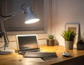 A comfortable workplace with a computer and lamp on the wooden desk in the home Office Royalty Free Stock Photo