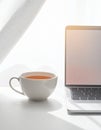 Cup of Tea beside Laptop on Minimal Desk Royalty Free Stock Photo