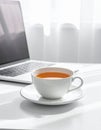 Cup of Tea beside Laptop on Minimal Desk Royalty Free Stock Photo