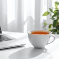 Cup of Tea beside Laptop on Minimal Desk Royalty Free Stock Photo