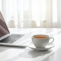 Cup of Tea beside Laptop on Minimal Desk Royalty Free Stock Photo