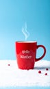 Red mug with words Hello winter on the blue background. Royalty Free Stock Photo