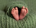 baby legs on green wool blanket Royalty Free Stock Photo