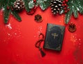 Christmas red background with Bible and rosary on the table Royalty Free Stock Photo