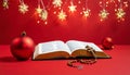 Christmas red background with Bible and rosary on the table Royalty Free Stock Photo