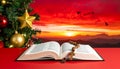Christmas red background with Bible and rosary on the table Royalty Free Stock Photo
