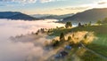 The beautiful view of the houses and trees covered in morning mist. Royalty Free Stock Photo