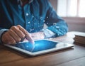 Digital marketing. A businessman using a tablet computer at the table. Symbols coming Royalty Free Stock Photo