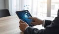 Digital marketing. A businessman using a tablet computer at the table. Symbols coming Royalty Free Stock Photo