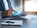 Digital marketing. A businessman using a tablet computer at the table. Symbols coming Royalty Free Stock Photo