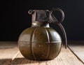 A green, segmented hand grenade with a metal safety lever and pull ring. Royalty Free Stock Photo