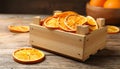 Crate of dry orange slices on wooden table, closeup Royalty Free Stock Photo