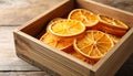 Crate of dry orange slices on wooden table, closeup Royalty Free Stock Photo