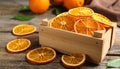 Crate of dry orange slices on wooden table, closeup Royalty Free Stock Photo