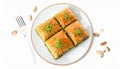Plate of delicious baklava with pistachio nuts on white background, top view Royalty Free Stock Photo