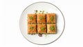Plate of delicious baklava with pistachio nuts on white background, top view Royalty Free Stock Photo