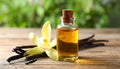 Aromatic vanilla extract, pods and flower on wooden table, closeup Royalty Free Stock Photo