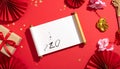 Chinese New Year Decorations with Gold Coins, Gift Box, and Calligraphy Scroll Royalty Free Stock Photo